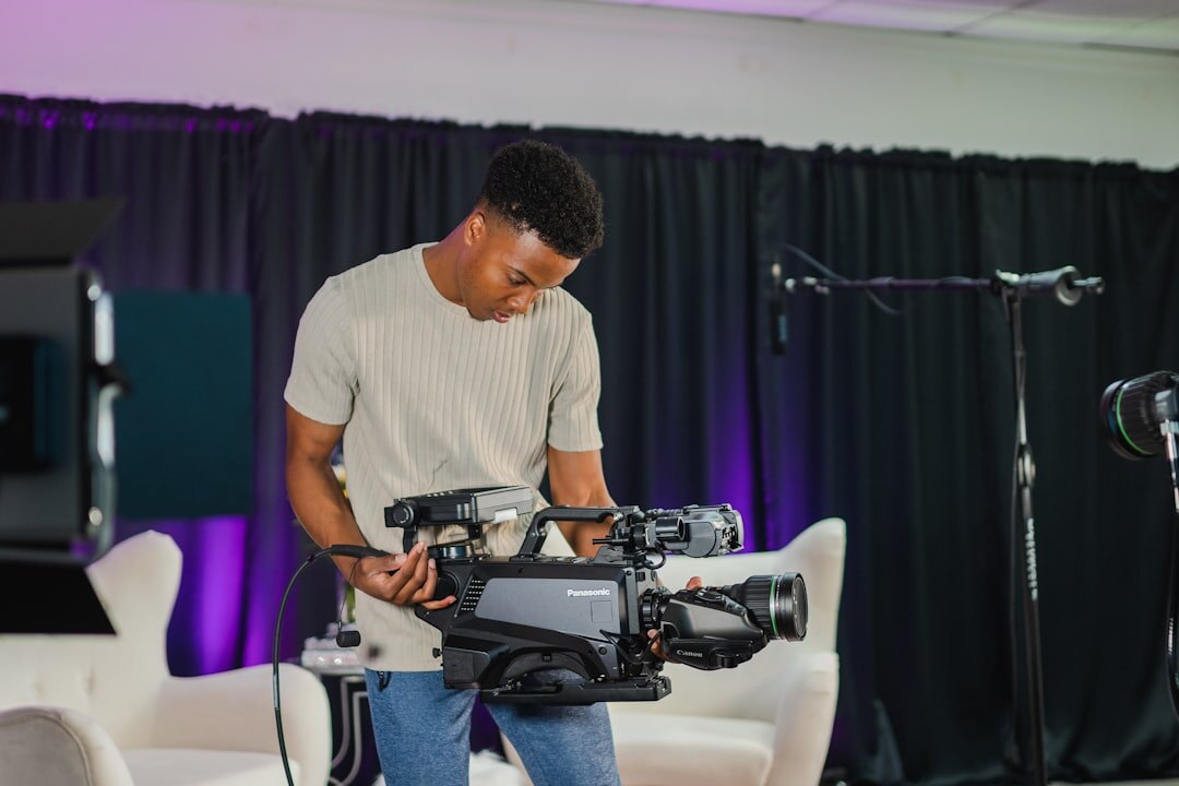 Presenter practicing in front of a broadcast camera with studio lights